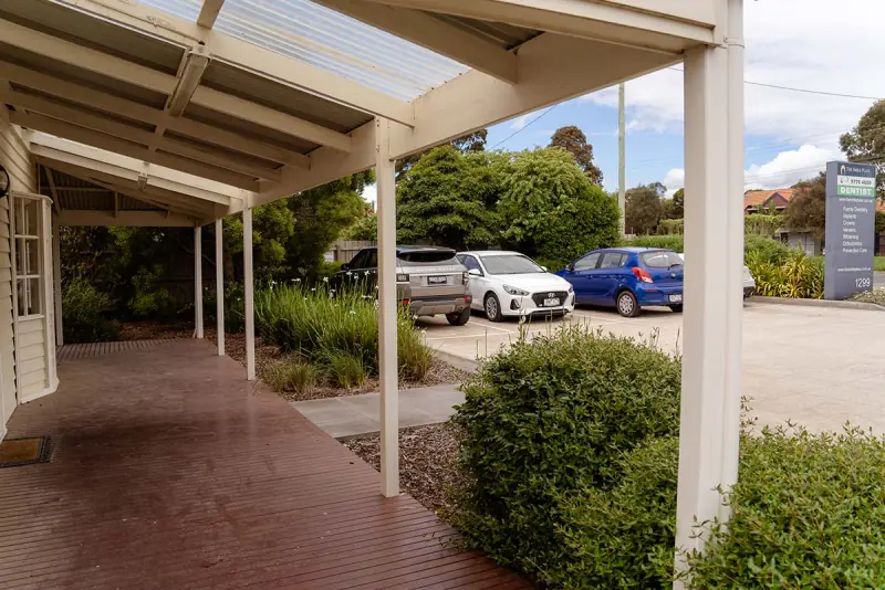The covered walkway leading to the practice parking